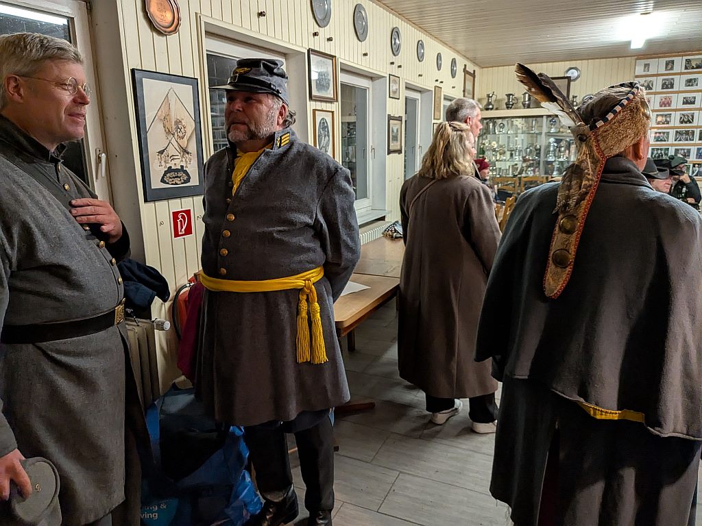 Campteilnehmer in historischen Uniformen und Gewandungen im Gespräch